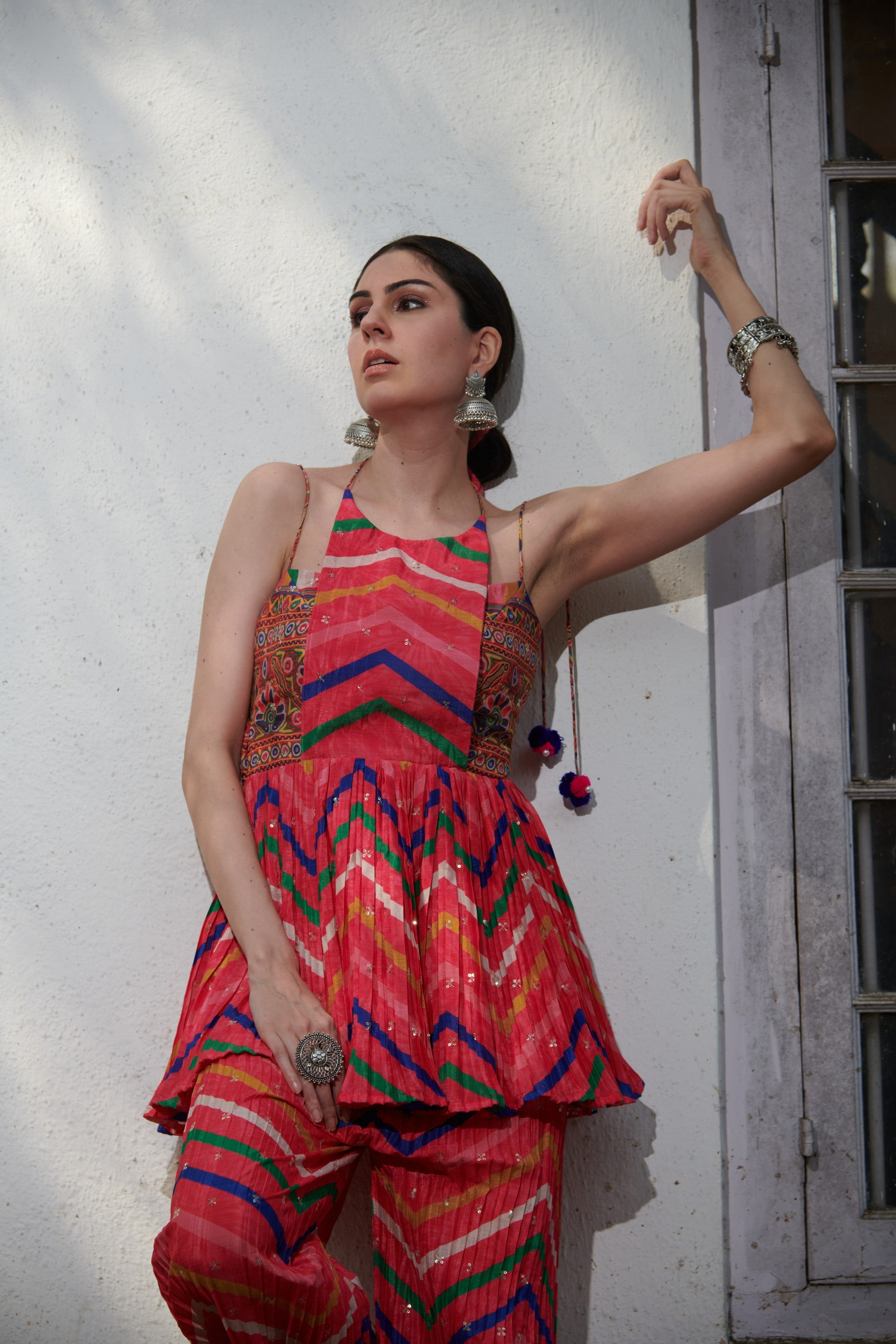 Woman wearing a multicolor sleeveless kurta set, front view showcasing halter neckline and zigzag print – ideal for festive occasions.